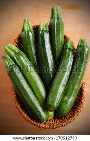 green zucchini in small basket