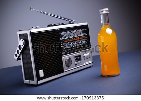 retro radio and the bottle of orange drink