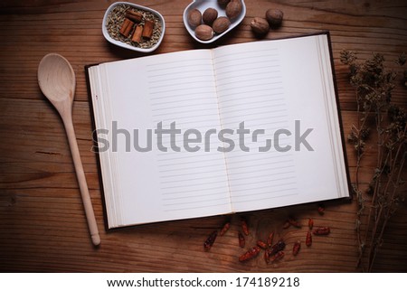 recipe book opened with blank pages on the table