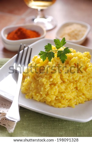 saffron risotto garnished with parsley, Italian traditional recipe