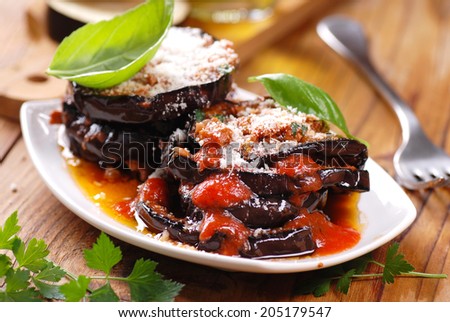 eggplant parmesan decorated with basil leaves