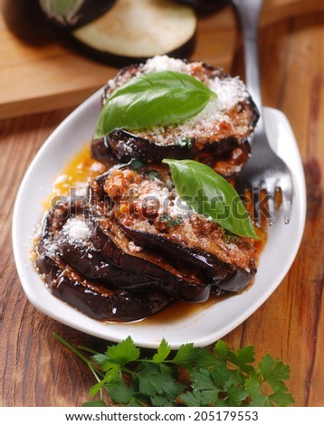 eggplant parmesan decorated with basil leaves