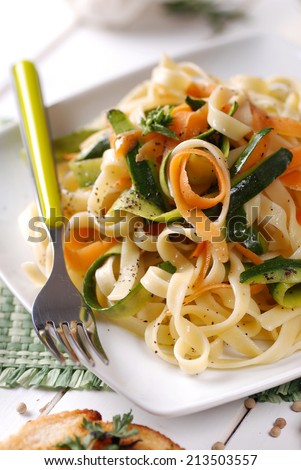Italian pasta noodles with assorted vegetables in square dish