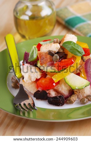 panzanella - traditional Italian salad with peppers, stale bread, cucumbers, olives and capers