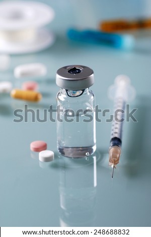insulin vial with the syringe on the table