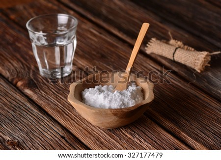 baking soda into the bowl with wooden spoon