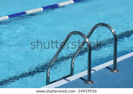 Metal chromeplated ladder in open pool