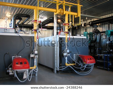 Interior of independent modern gas boiler-house with two steel boilers