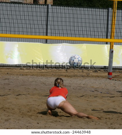 The girl beats off a ball. Beach volleyball