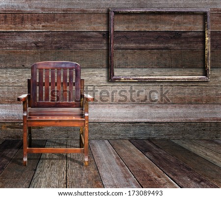 Picture frame and wood chair in wood room.