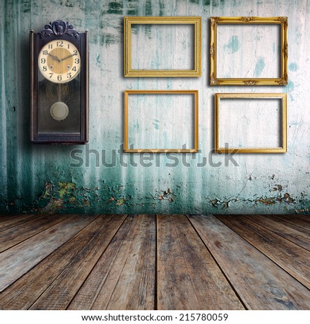 Old clock and empty picture frame in old room.