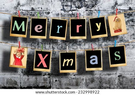 Merry christmas words hanging on clothesline on grunge background.