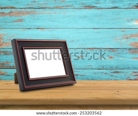 Picture frame put on wood table in wood wall room.