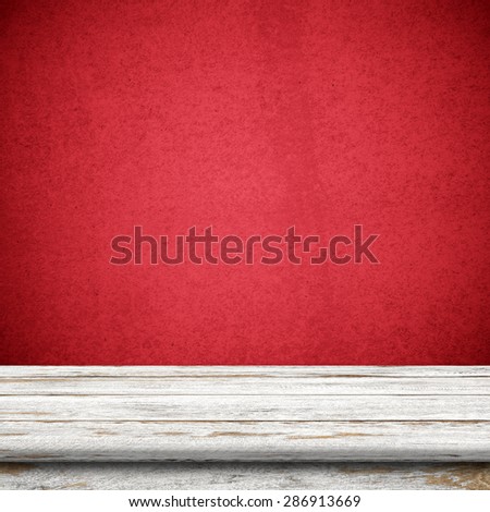 Vintage wood table in red wall room.