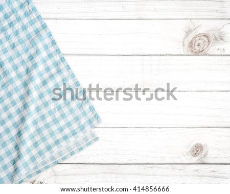 Blue tablecloth on white wooden table with copy space.