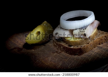 Sandwich made of herring on boiled jacket potato and rye bread