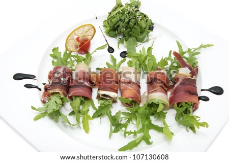 rolls of meat and greens on a white background in the restaurant