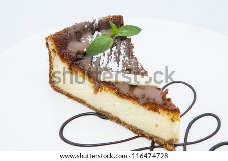 cheese cake decorated with chocolate mint on a white background