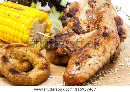 chicken wings are grilled on a wooden platter