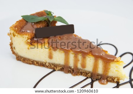 a piece of cheese cake decorated with mint on a white background