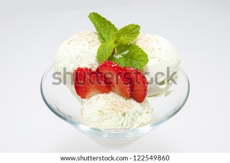fruit with ice cream on a white dish at restaurant