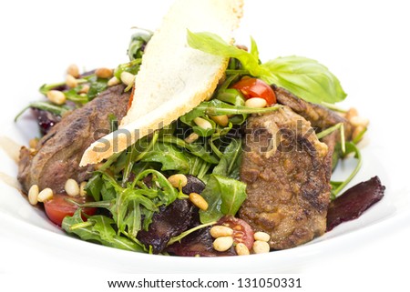 rabbit liver salad with arugula in a restaurant