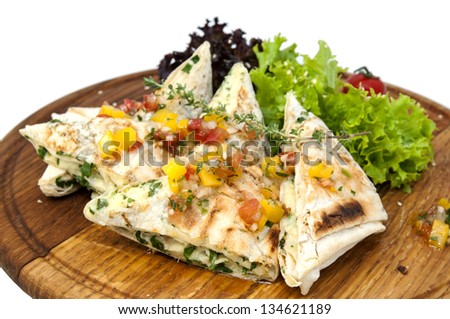 pita bread with vegetables on a plate in a restaurant