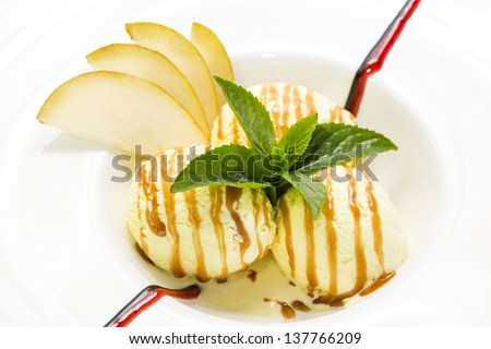 ice cream with caramel sauce and mint on a white background