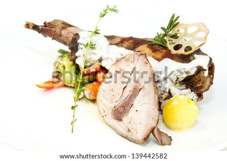 roasted rabbit meat and potatoes with vegetables
