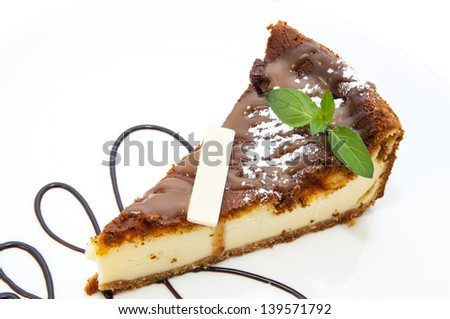 piece of cheese cake decorated with mint on a white background