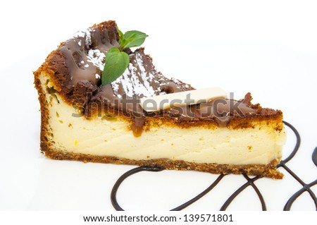 a piece of cheese cake decorated with mint on a white background