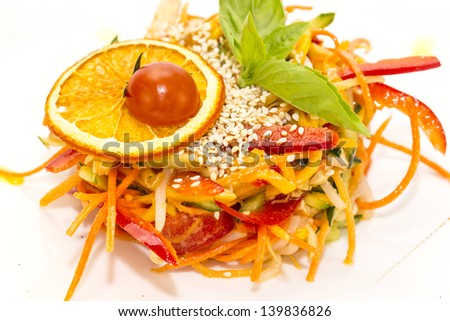 salad of steamed vegetables on a white plate in a restaurant