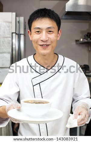 Japanese chef with a plate of sushi