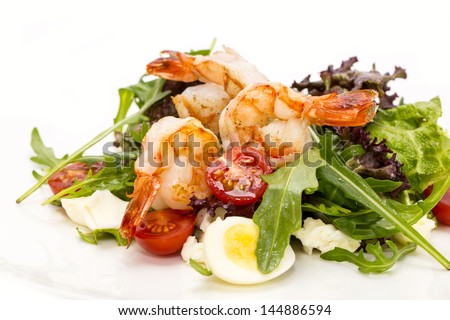 salad greens and shrimp on a white background in the restaurant
