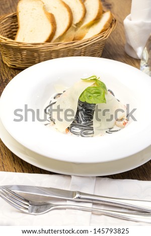 Black spaghetti with white sauce with cheese