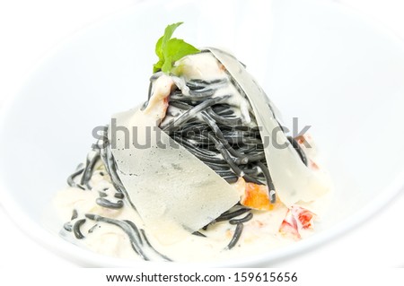 Black spaghetti with white sauce with cheese