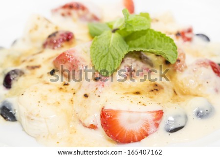 berries in cream sauce on a white background in the restaurant