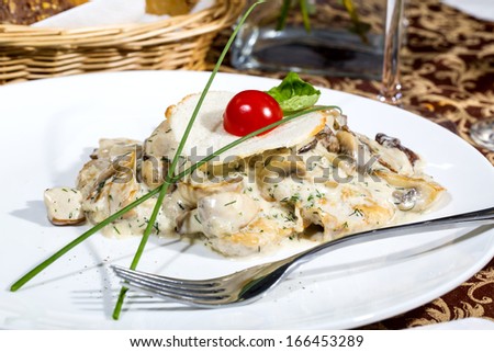mushrooms in a cream sauce with steamed vegetables on a white background in the restaurant