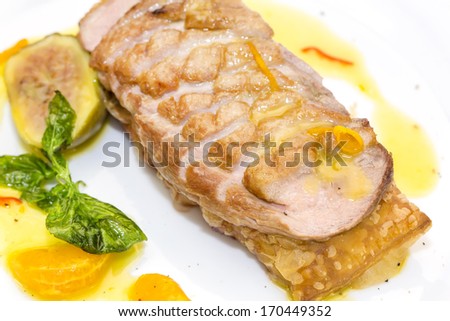 goose breast cooked on griles tangerine sauce on a white background in restaurant