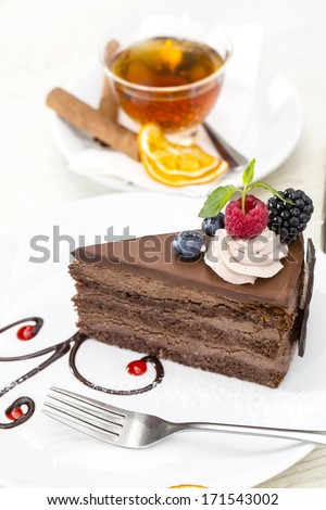 Prague Piece Of Cake Decorated With Raspberries On A White Background