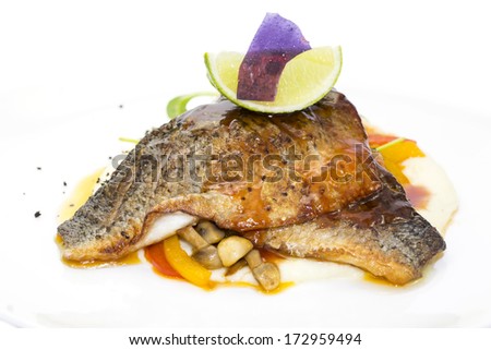baked fish with vegetables and mushrooms in a restaurant