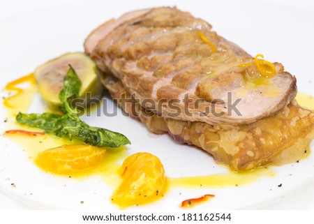 goose breast cooked on griles tangerine sauce on a white background in restaurant
