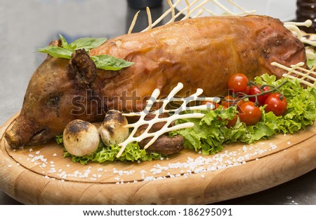 roasted pig with herbs and vegetables