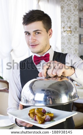 waiter with a tray of food in the restaurant hall