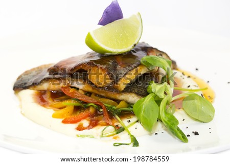 baked fish with vegetables and mushrooms in a restaurant