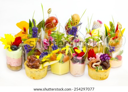 canaps with edible flowers meat cheese and seafood