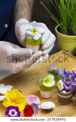 cook prepares canapes dessert edible flowers and buds