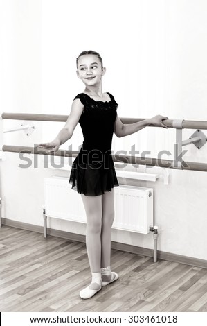 a little girl dressed as a ballerina in ballet