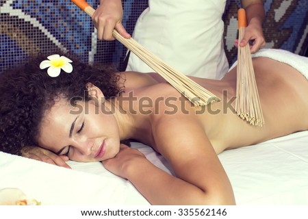 Japanese massage with bamboo sticks in the spa salon
