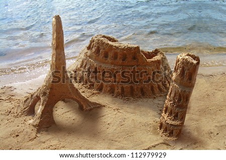 Travel around the world. Famous landmarks made of sand - Coliseum, Eiffel tower, Pisa tower